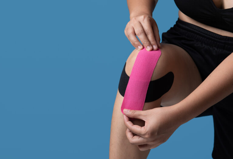 Kinesiological tape pink and black,muscle tape on athlete patient injured knee,Taping problem areas and pain relief